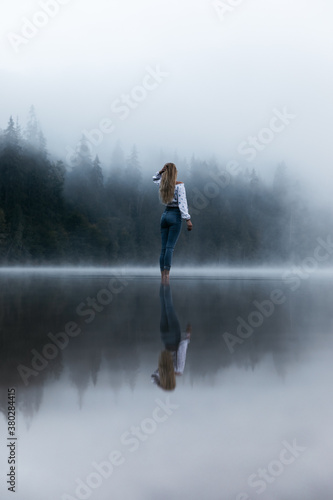 Young woman standing in mis...