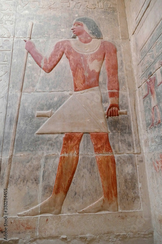 Painted bas relief figures showing daily life in ancient Egypt photo