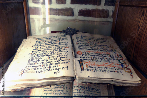 Ancient religious codex in both Coptic and Arabic calligraphy photo