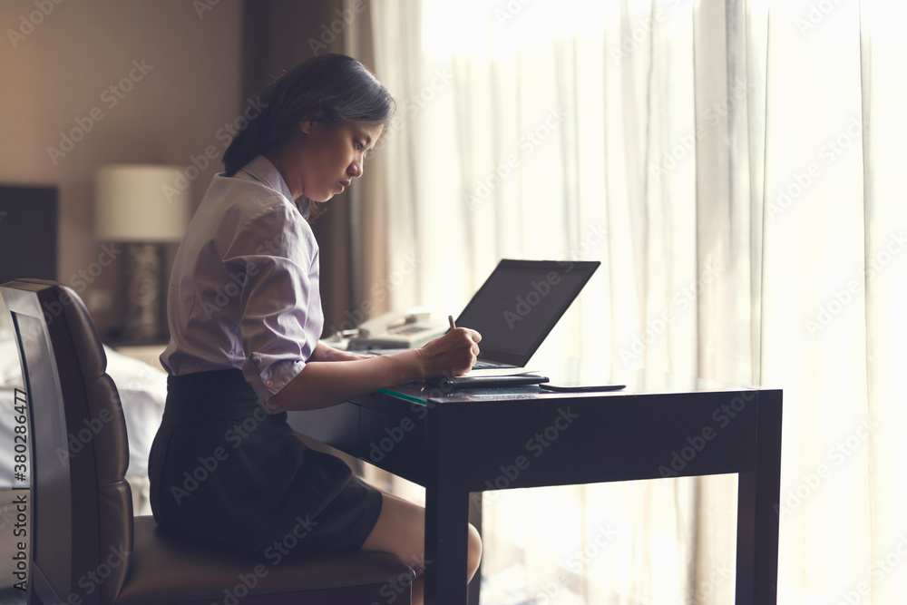 Young female working and writing on desk Young female working and writing on desk