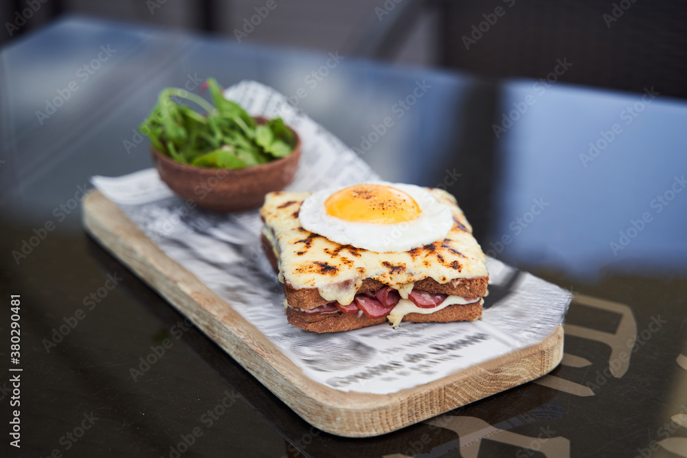 Wooden cutting board with delicious breakfast on it
