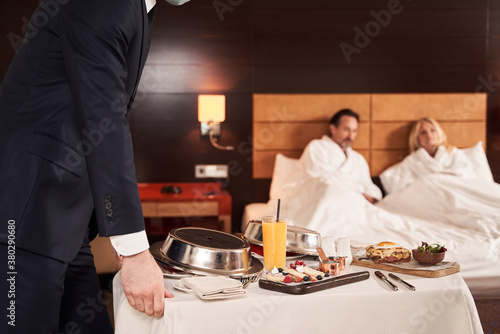 Couple ordering the service of breakfast in bed