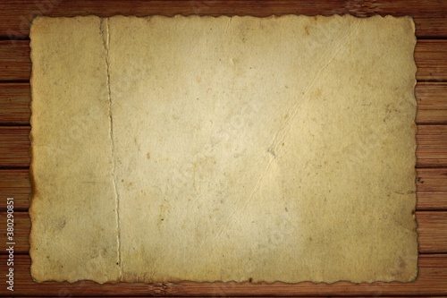 old card of paper on wooden boards background 