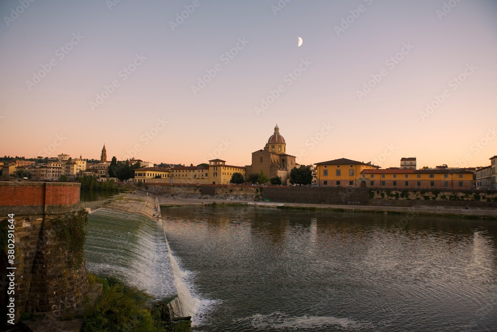 Dusk over the river Arno in Florence, Tuscany, Italy, with the Santa Rosa weir, and the Church of San Frediano in Cestello‎ opposite