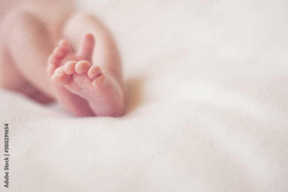 Closeup of a newborn baby's feet on a white blanket Closeup of a newborn baby's feet on a white blanket