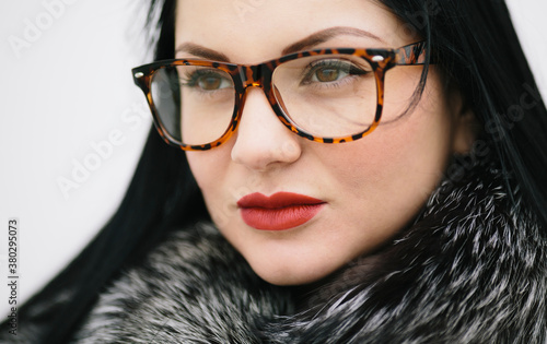 winter portrait of young woman with glasses and fur photo