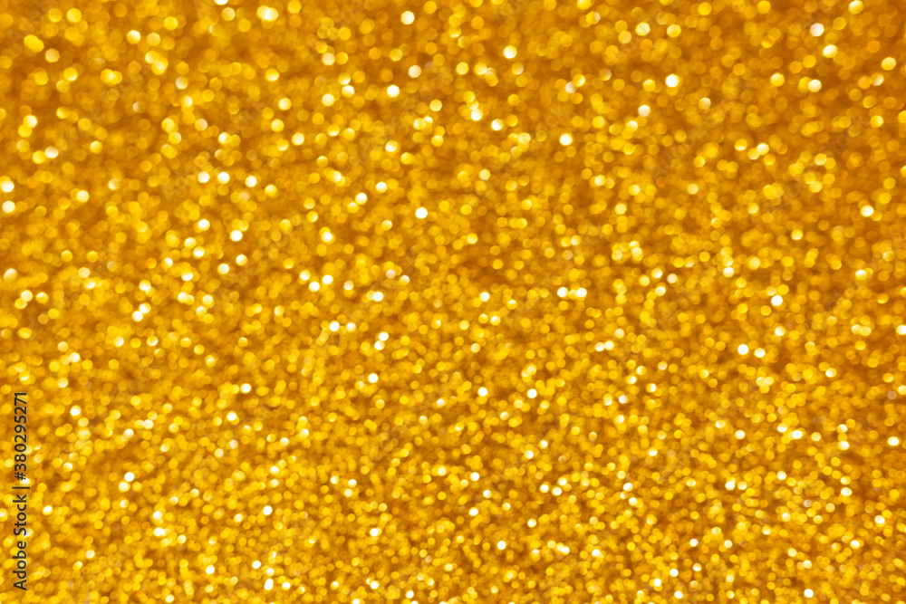 Golden abstract defocused bokeh background. Sparkling texture. Golden abstract defocused bokeh background. Sparkling texture.