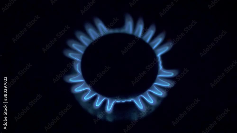 Kitchen burner turning on.Stove top burner igniting into a blue cooking flame. Natural gas inflammation, close up Kitchen burner turning on.Stove top burner igniting into a blue cooking flame. Natural gas inflammation, close up