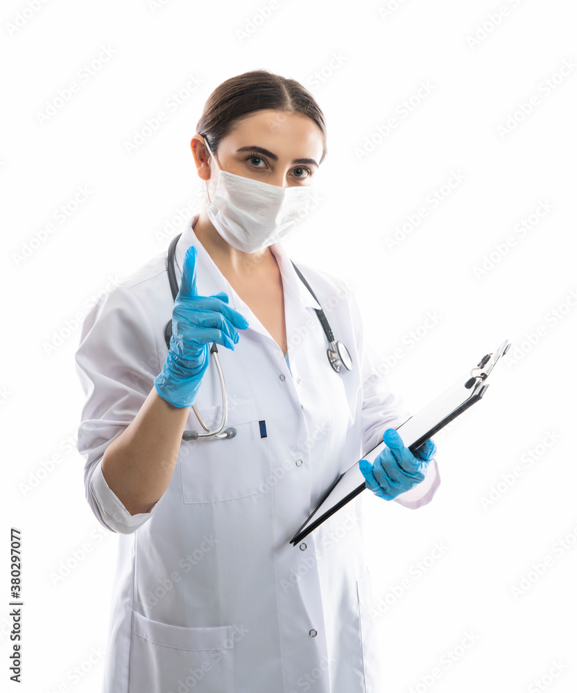 Confident doctor in protective wear and face mask wearing gloves stock