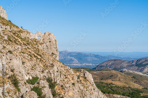 Forata rock hole with the city of Cocentaina in the background, Aitana mountain. © Pablo Eskuder