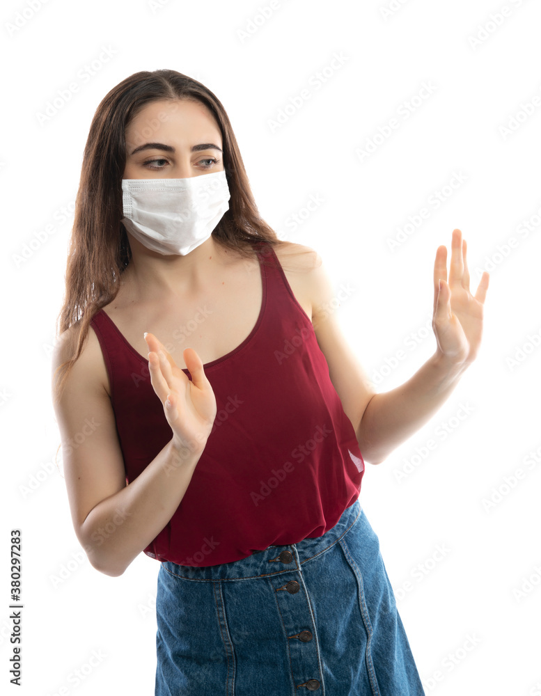 Beautiful caucasian young woman with disposable face mask. Protection versus viruses and infection. Studio portrait, concept with white background. She shocked and holds her head Beautiful caucasian young woman with disposable face mask. Protection versus viruses and infection. Studio portrait, concept with white background. She shocked and holds her head