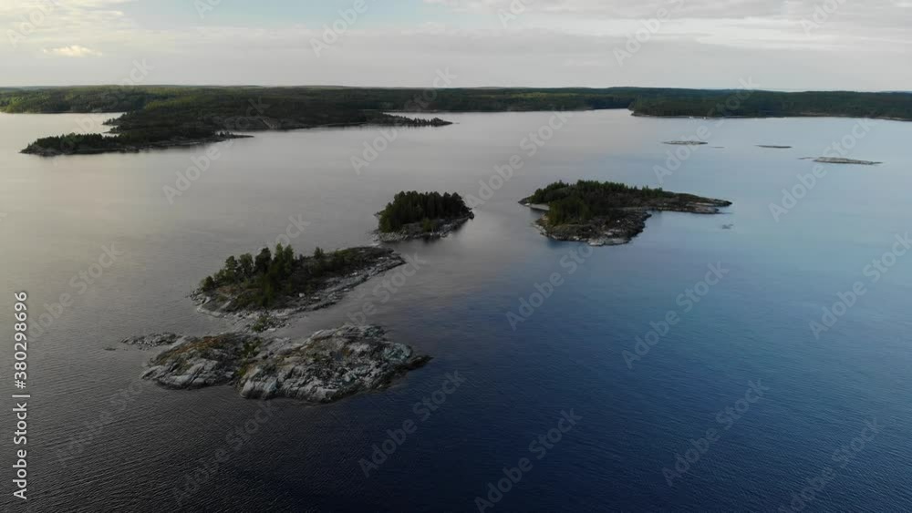aerial view Island with rocky shore and pine forest in Russian Karelia. Ladoga. aerial view Island with rocky shore and pine forest in Russian Karelia. Ladoga.