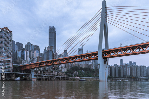 Panorama view of the Qiansimen bridge and skyline in Chongqing, China, on a cloudy day.