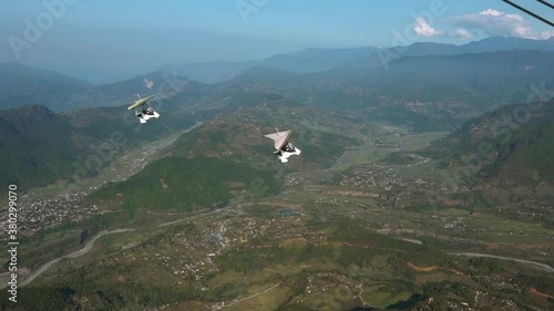 Wide shot of motor glider flying, Pokhara, Nepal photo