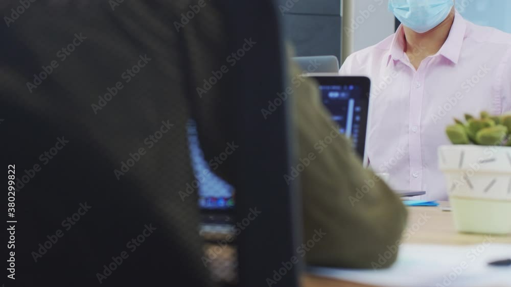 Over the Shoulder of Man In Face Mask Reading Notebook Over the Shoulder of Man In Face Mask Reading Notebook
