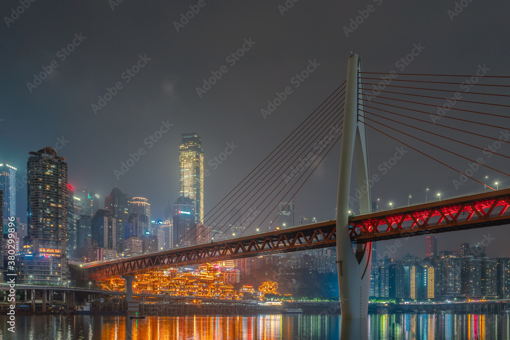 Obraz premium Night view of the Qiansimen bridge and the skyline in Chongqing, China.