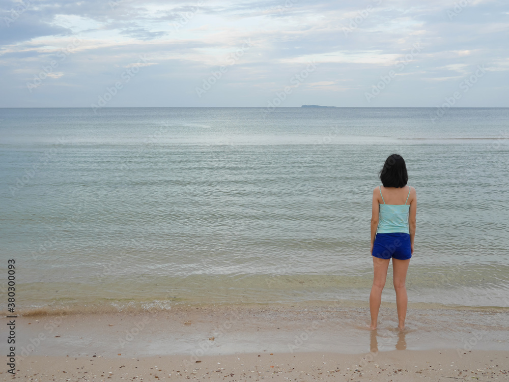 Woman standing on the beach Woman standing on the beach