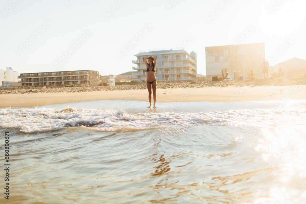 Beautifully sexy young woman stands on the ocean shore Beautifully sexy young woman stands on the ocean shore