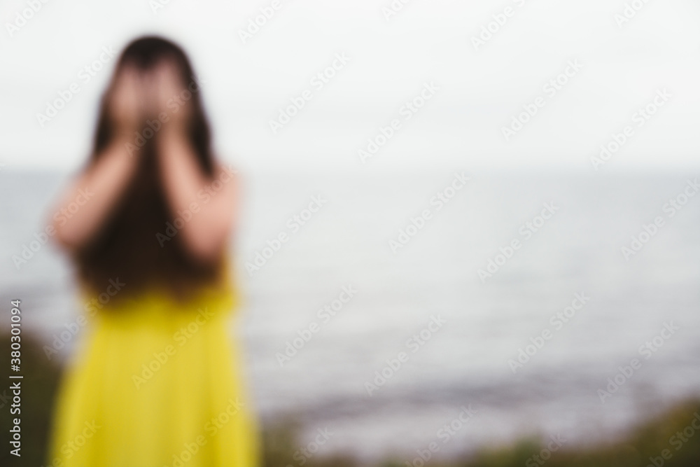 De-Focused Girl in Yellow Dress Covering Her Face with Her Hands Stock ...