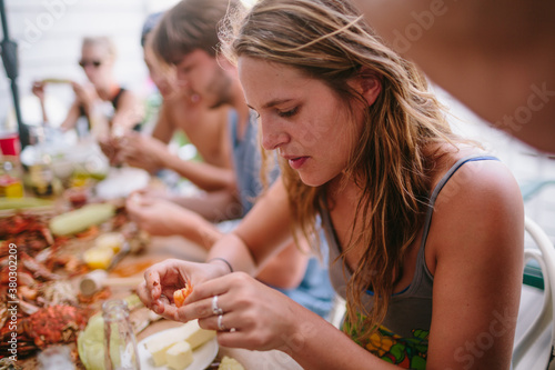 Young woman eating crab on Maryland coast photo