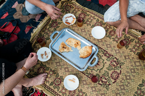 Travellers eating fermented mare's milk and bread, Kyrgyzstan. photo