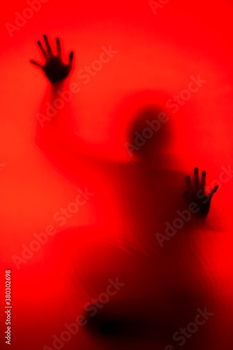 Silhouette of a woman behind the glass