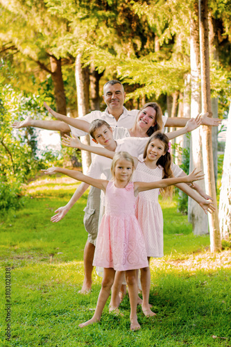Beautiful family in the summer on a picnic in a green park.