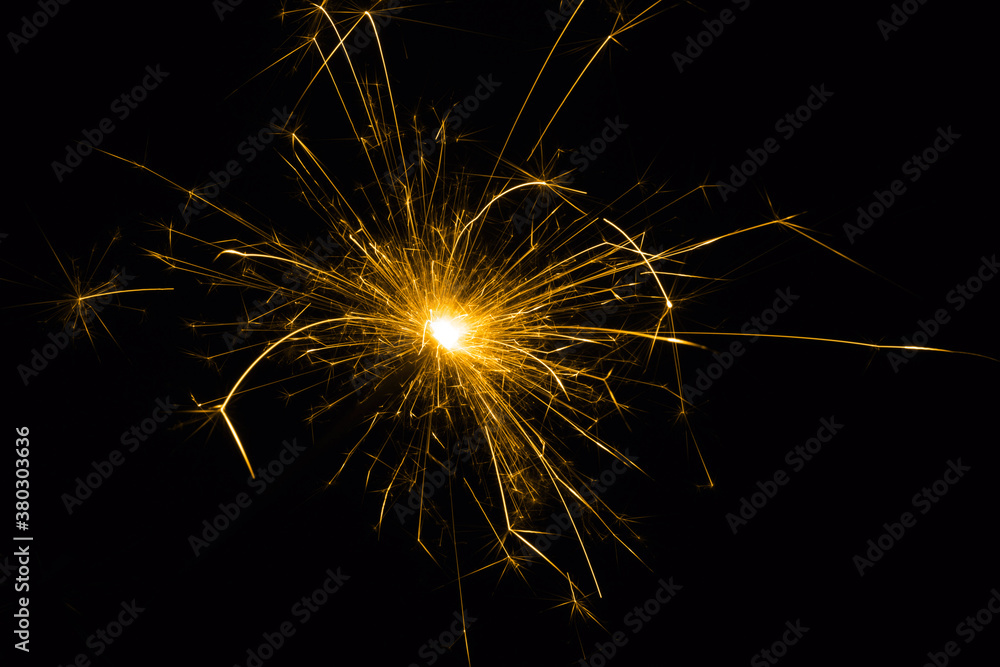 Sparkler on a black background.Close-up of burning sparkler.Fireworks in flame on black background.Christmas sparkler.
