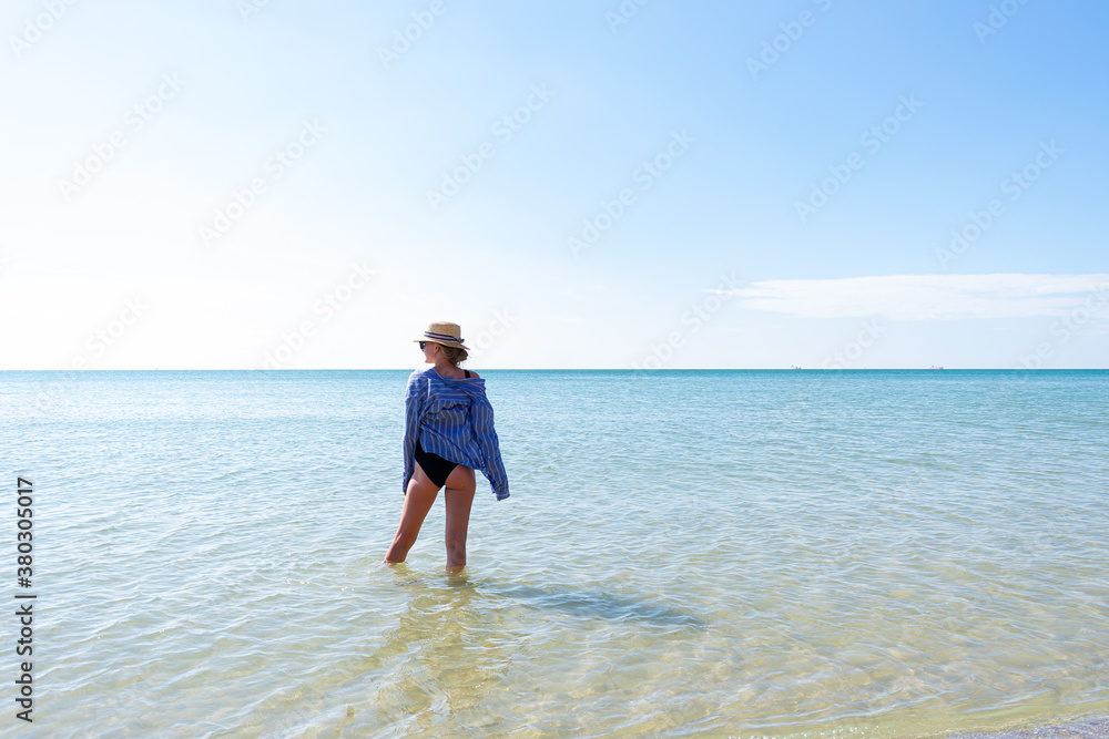 Woman in black swimsuit on the beach