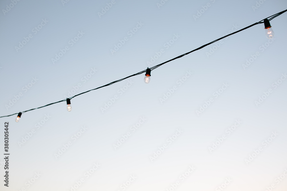 String of twinkle lights against sky String of twinkle lights against sky
