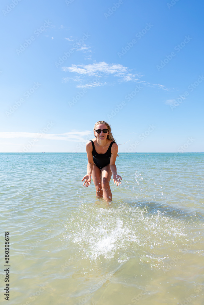 Woman in black swimsuit on the beach