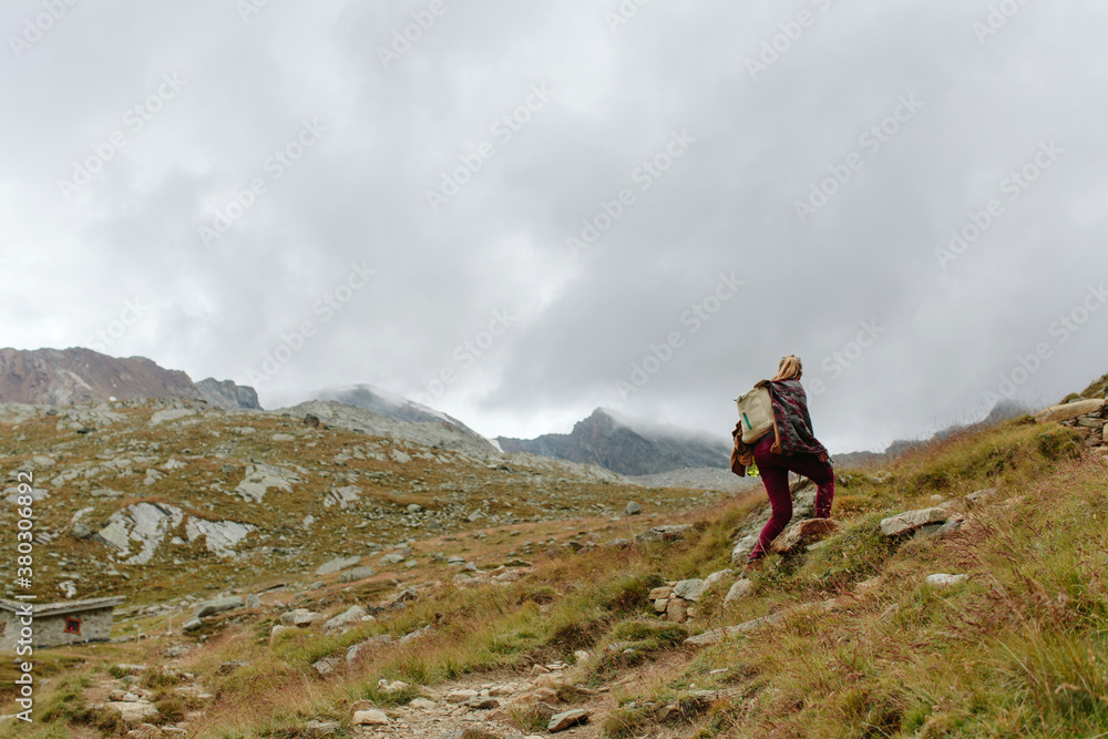 Woman hiking up in the mountains. Woman hiking up in the mountains.