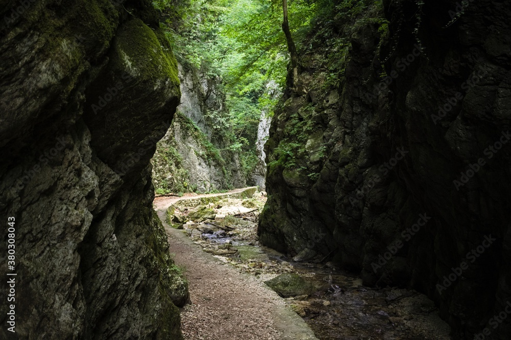 An hiking path in a gorge among the rocks in the Sibillini mountains (Marche, Italy, Europe)