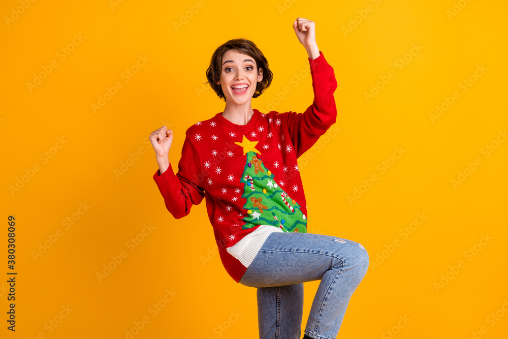 Photo of excited girl in christmas tree decor pullover sweater denim jeans raise fists x-mas newyear lottery win isolated over bright shine color background Photo of excited girl in christmas tree decor pullover sweater denim jeans raise fists x-mas newyear lottery win isolated over bright shine color background