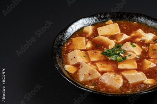 Material of traditional chinese food,Mapo Tofu dressed with black background.
