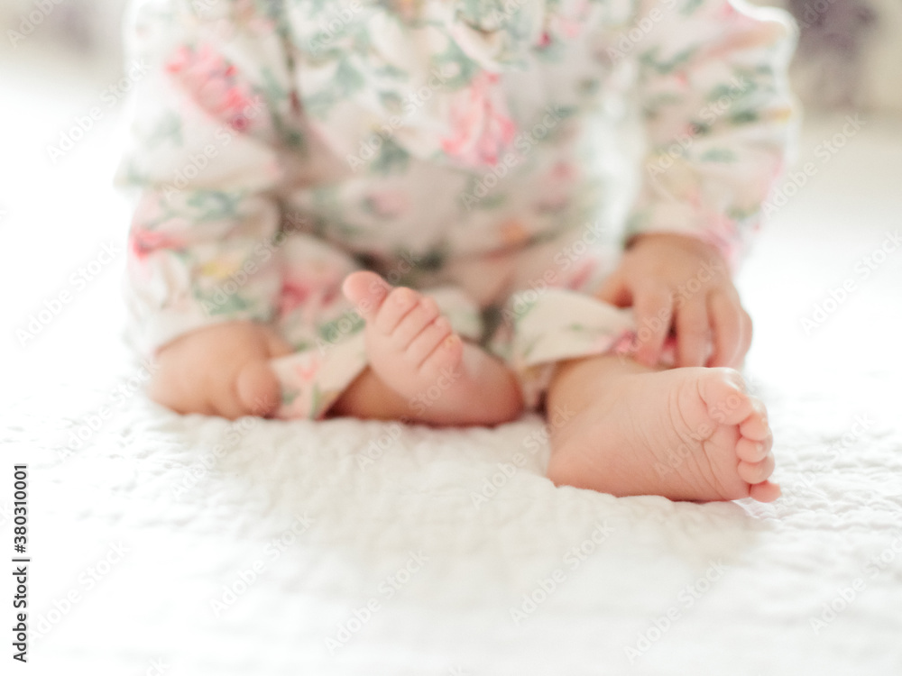 Close up of baby's feet while sitting Close up of baby's feet while sitting