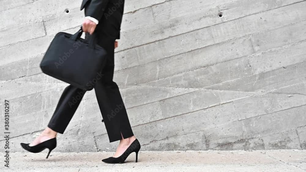 Unrecognizable Business Woman with Briefcase is Walking in City. Close up, slow motion. High quality FullHD footage Unrecognizable Business Woman with Briefcase is Walking in City. Close up, slow motion. High quality FullHD footage