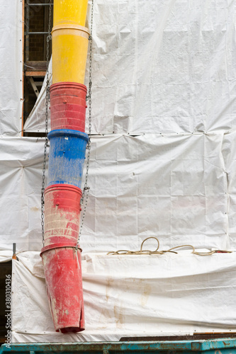 Construction site with plastic tarp and rubble chute