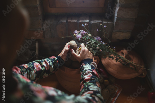 Woman hands peeling potato