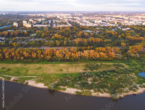 Meadown over a river in a city. Drone, aerial view