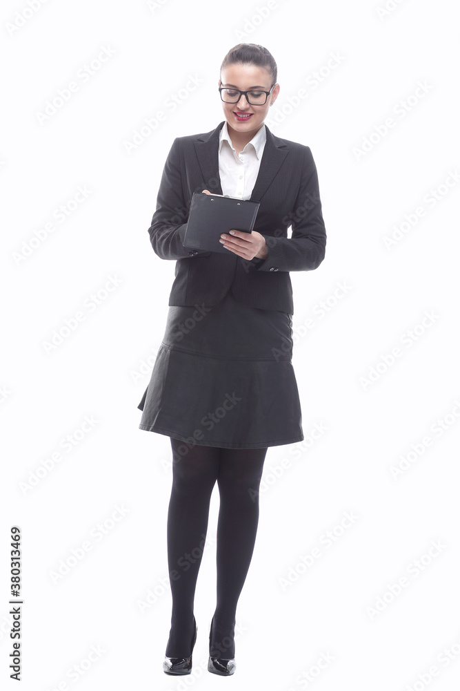 in full growth. smiling businesswoman taking notes in the clipboard in full growth. smiling businesswoman taking notes in the clipboard