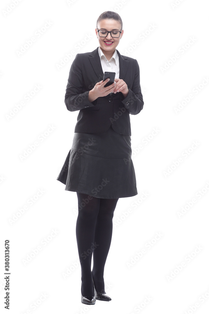 in full growth. smiling businesswoman reading a message on her smartphone. in full growth. smiling businesswoman reading a message on her smartphone.