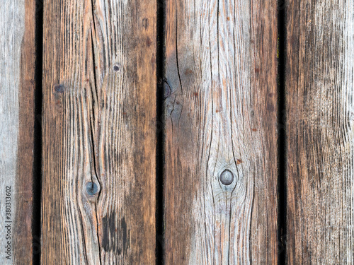 wet shabby wooden planks of outdoor paving of pier close up