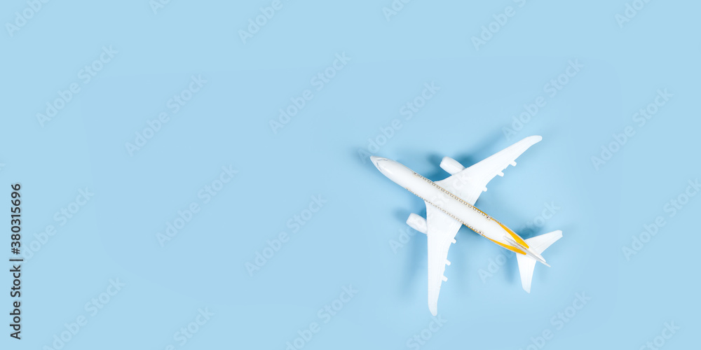 model of passenger airplane on blue background. Flat lay travel concept design. Copy space