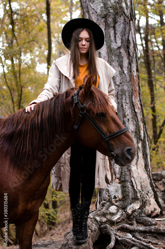 girl with a horse in the forest