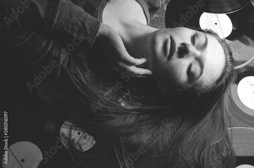 girl lying on the floor in vinyl records