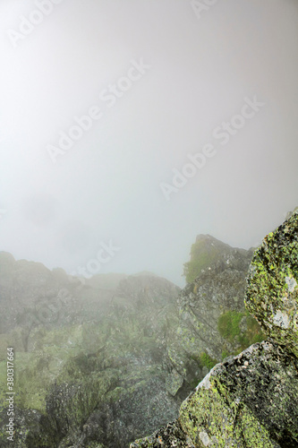 Fog, clouds, rocks and cliffs on Veslehødn Veslehorn mountain, Norway. photo