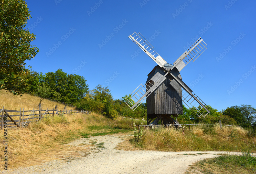 Beautiful view to a traditonal wooden wind mill in Germany