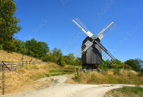 Beautiful view to a traditonal wooden wind mill in Germany photo