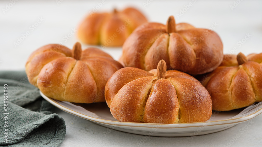 Pumpkin buns bread with spices on grey background. Halloween Food Concept. Autumn concept. Pumpkin buns bread with spices on grey background. Halloween Food Concept. Autumn concept.